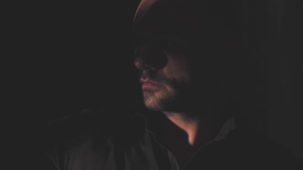 Porträt eines Mannes im schwarzen Hemd. Licht und Schatten — Stockvideo