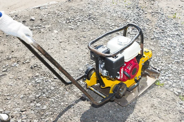 Yellow vibratory plate — Stock Photo, Image