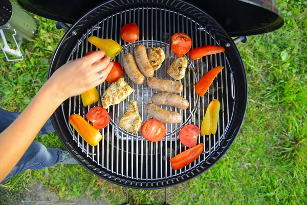 Saucisses, viande et légumes sur un gril — Photo