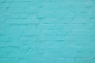 Turkuaz renge boyanmış tuğlalardan yapılmış tuğla duvar cephesinin dokusu