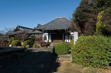 Tokyo, Japan - January 09, 2016:  Enmei-ji Temple in Yanaka, Tokyo - Japan.Yanaka  is one of the few districts in Tokyo where the shitamachi atmosphere, an old town ambience reminiscent of Tokyo from past decades, still survives. clipart