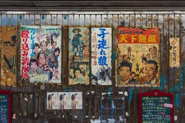 Tokyo, Japan - December 10, 2015: TOld vintage japanese posters of samurai or yakuza retro movies at the at Yuraku Concourse , Tokyo, Japan clipart