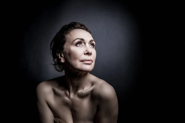 Retrato de uma sensual mulher de cinquenta anos em fundo estúdio cinza — Fotografia de Stock