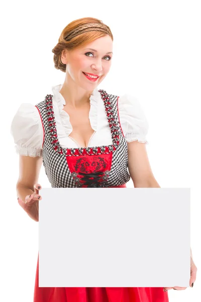 Bavorské žena v dirndlu, drží prázdná tabulka. — Stock fotografie
