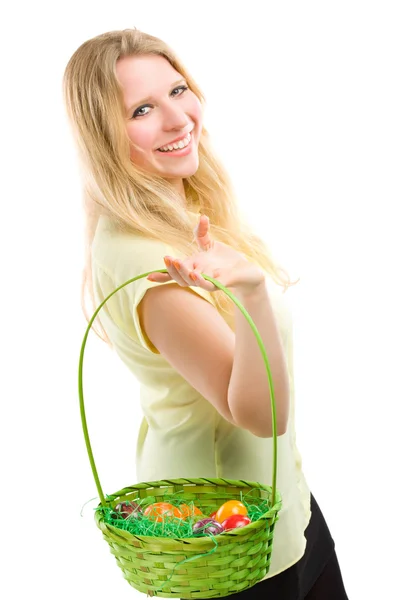 Girl holding basket of colored eggs for easter — Stock Photo, Image