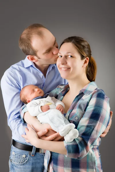 Mother and father holding their newborn baby — Stock Photo, Image