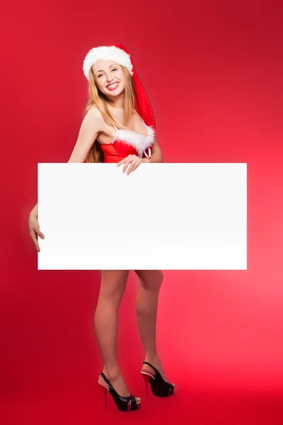 Santa mulher apontando para quadro branco em branco — Fotografia de Stock