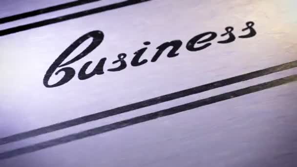 "business" on a paper. — Stock Video