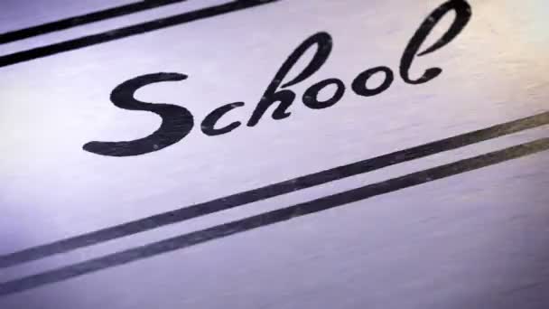"School" on a paper. Looping. — Stock Video