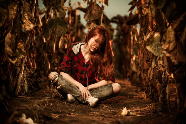 Sad woman in sunflowers — Stock Photo, Image