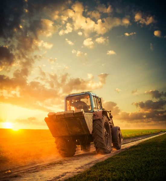 Vintage tractor at sunset field — Stock Photo, Image
