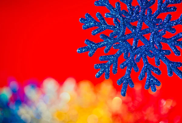 Blue snowflake on red background — Stock Photo, Image