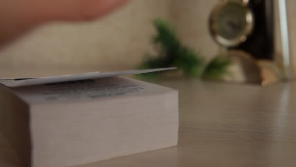 The hand quickly flipping through the pages of a new tear-off calendar — Stock Video