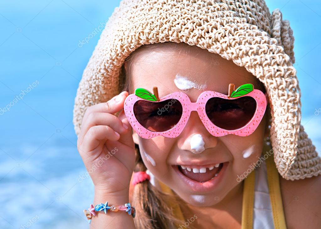 Happy kid with glasses on the nose with sunscreen on your face Stock