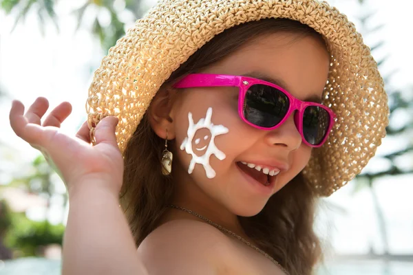 Happy child with glasses and sunscreen on your face — Stock Photo, Image