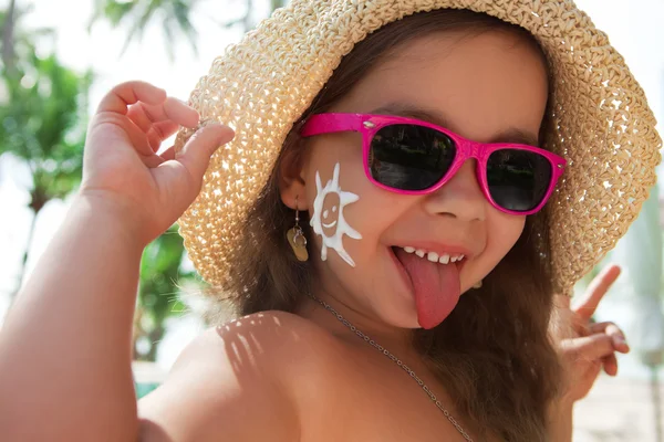 Happy child with glasses and sunscreen on your face — Stock Photo, Image