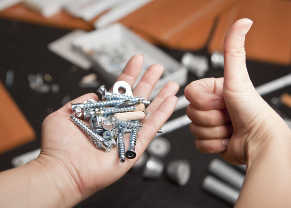 Fastening material in the hands against the background of the forthcoming Assembly