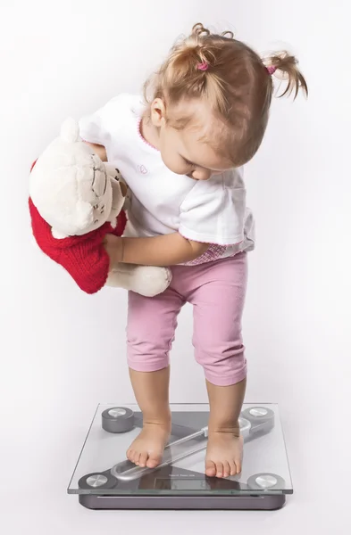 Baby on floor scales. — Stock Photo, Image