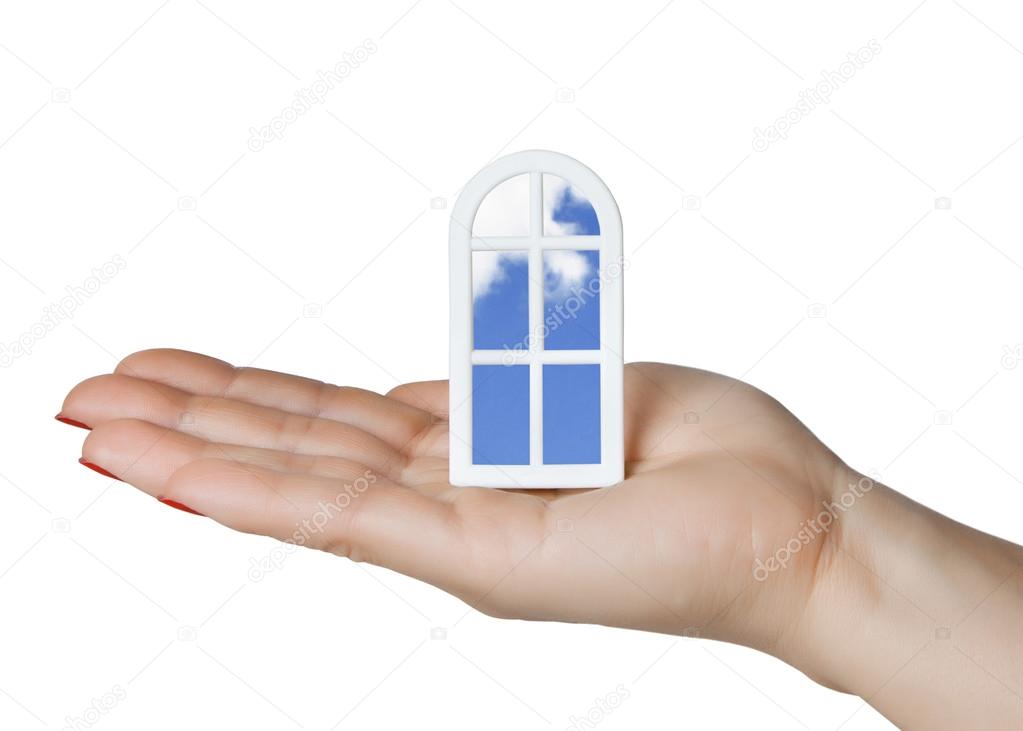 Beautiful model of a plastic window with a view of the sky in the palm of your hand