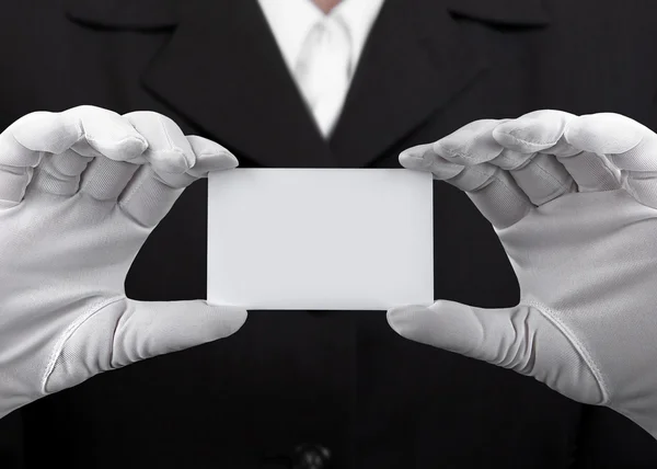 Hands in white gloves holding a plastic card — Stock Photo, Image