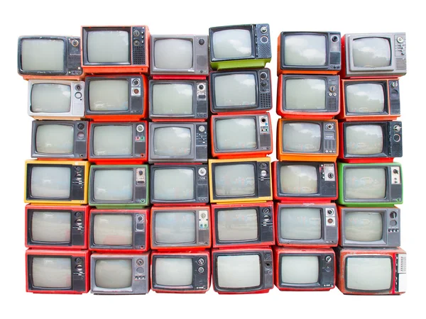 Muchos viejos televisores vintage se amontonan aislados en el fondo blanco Imagen de stock