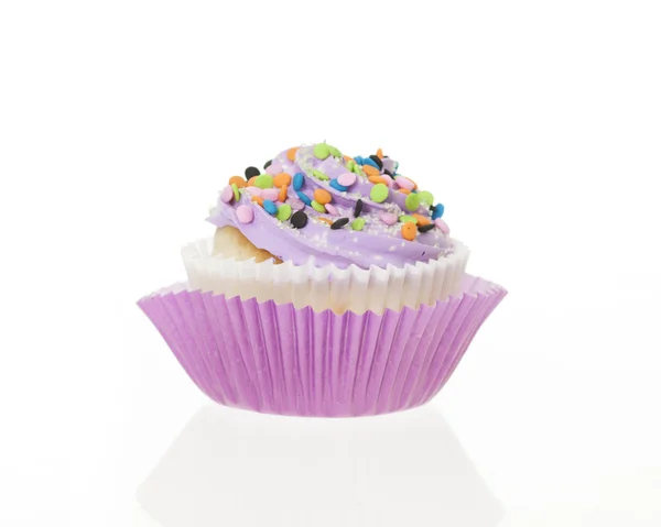 Purple icing with sprinkles cupcake, isolated. — Stock Photo, Image