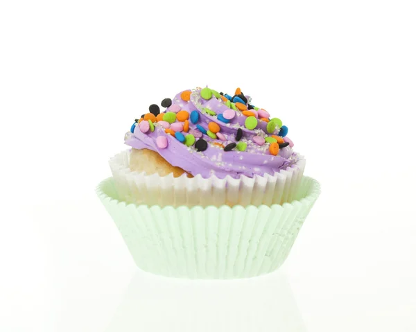 Purple icing with sprinkles cupcake, isolated. — Stock Photo, Image