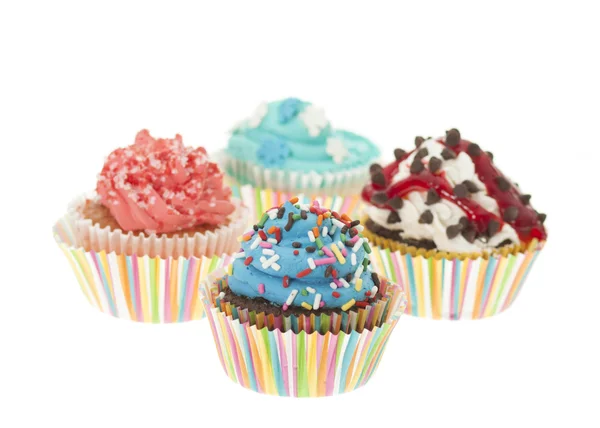 Grupp med fyra färgglada Cupcakes isolerade Stockbild