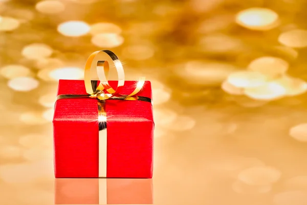 Geschenkbox mit goldenem Hintergrund — Stockfoto