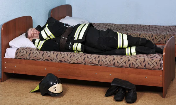 Firefighter sleeps — Stock Photo, Image