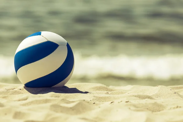 Retro looking ball on the beach Stock Image