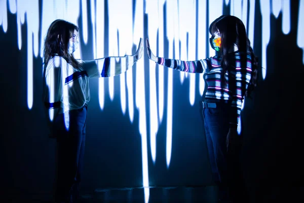 Two women raise their arms to measure safety distance by social distancing per covid19 — Stock Photo, Image