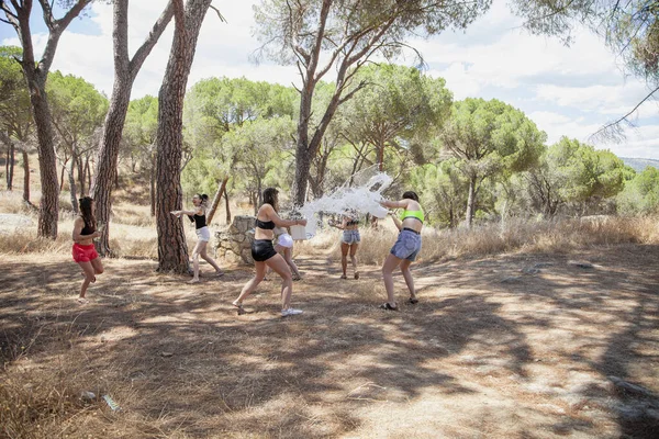 San martin de Valdeiglesias, Madrid, Espanha. Grupo de mulheres brincando com água para se refrescar no verão perto de uma fonte. — Fotografia de Stock