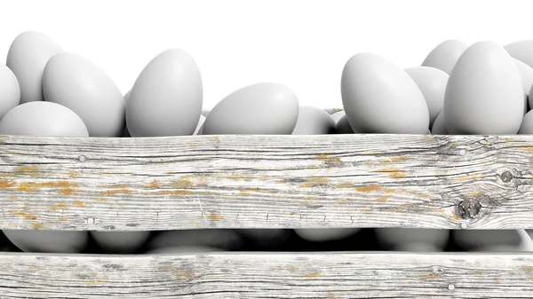 White eggs in old wooden container closeup, isolated on white. — Stock Photo, Image
