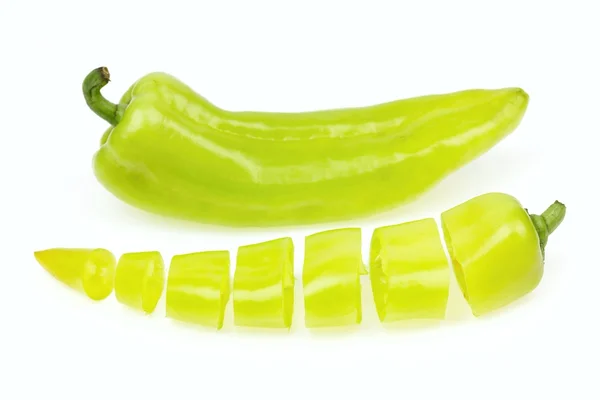 Pointy green pepper and one cut into pieces, on white background. — Stock Photo, Image