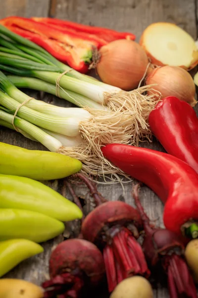 Various fresh raw vegetables on wooden surface — Stock Photo, Image