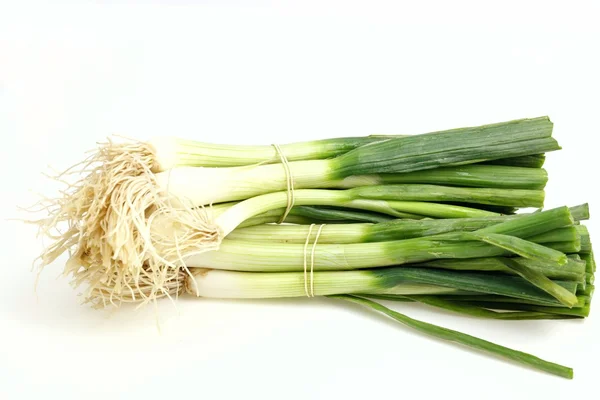 Heaps of green onions, on white background. — Stock Photo, Image