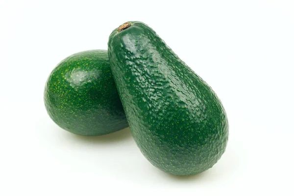 Due frutti di avocado, su sfondo bianco . — Foto Stock