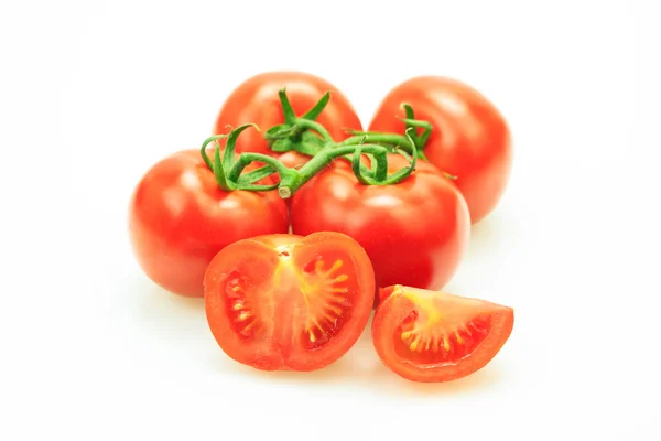 Tomatoes with stem with one cut in pieces, on white background. — Stock Photo, Image