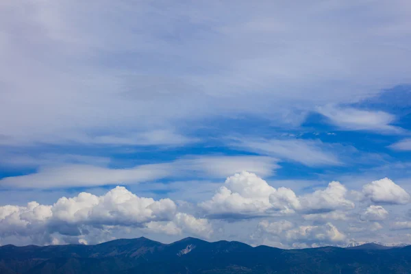 White clouds floating over land — Stock Photo, Image