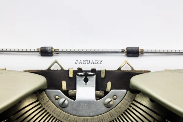Palabra de enero en mayúsculas en hoja blanca — Foto de Stock