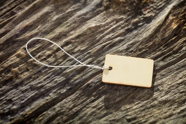 Close-up of wooden tag on white rope — Stock Photo, Image