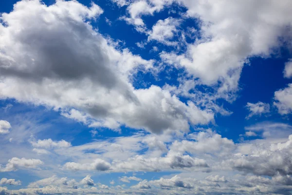 White fluffy clouds on heavenly blue sky Stock Image