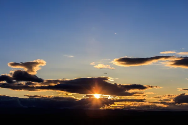 Amazing bright sunshine through dark clouds — Stock Photo, Image