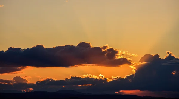 Majestic vivid sunset/sunrise with dark heavy clouds and sunrays — Stock Photo, Image