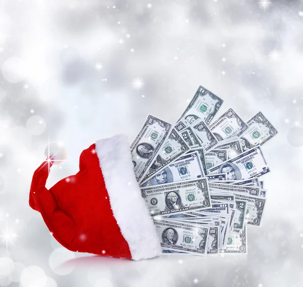 Dollar banknotes coming out of Santa Claus hat — Stock Photo, Image