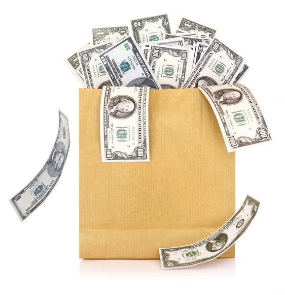 Dollar banknotes coming out of a paper bag on white background — Stock Photo, Image