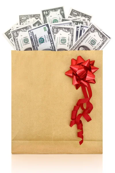 Dollar banknotes in a paper bag with red bow on white background — Stock Photo, Image