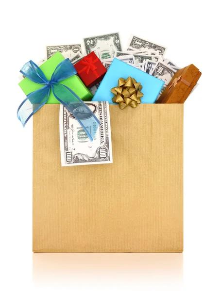 Money and gifts in a paper bag on white background — Stock Photo, Image