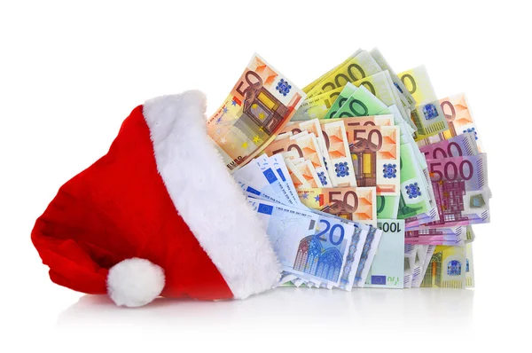 Notas de euro provenientes do chapéu de Papai Noel sobre fundo branco — Fotografia de Stock
